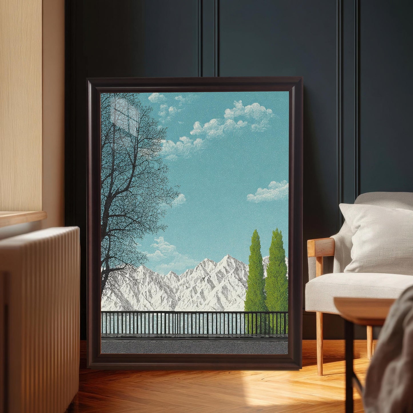 A large, dark Coffee brown wood framed art print featuring a mountain and lake scene, leaning on a herringbone wood floor next to a grey armchair in a moody, dark-walled room.