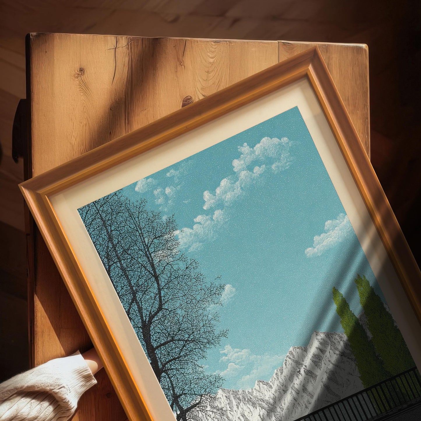 Close-up detail of an Orange wood frame with a white mount and plexiglass, showing the high-quality texture of the landscape art print under natural sunlight.