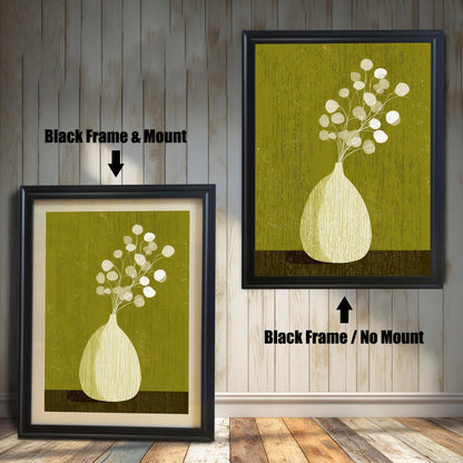 Comparison of the black wood frame options: showing the botanical print with a white mount (left) and without a mount (right) on a light wood paneled wall.