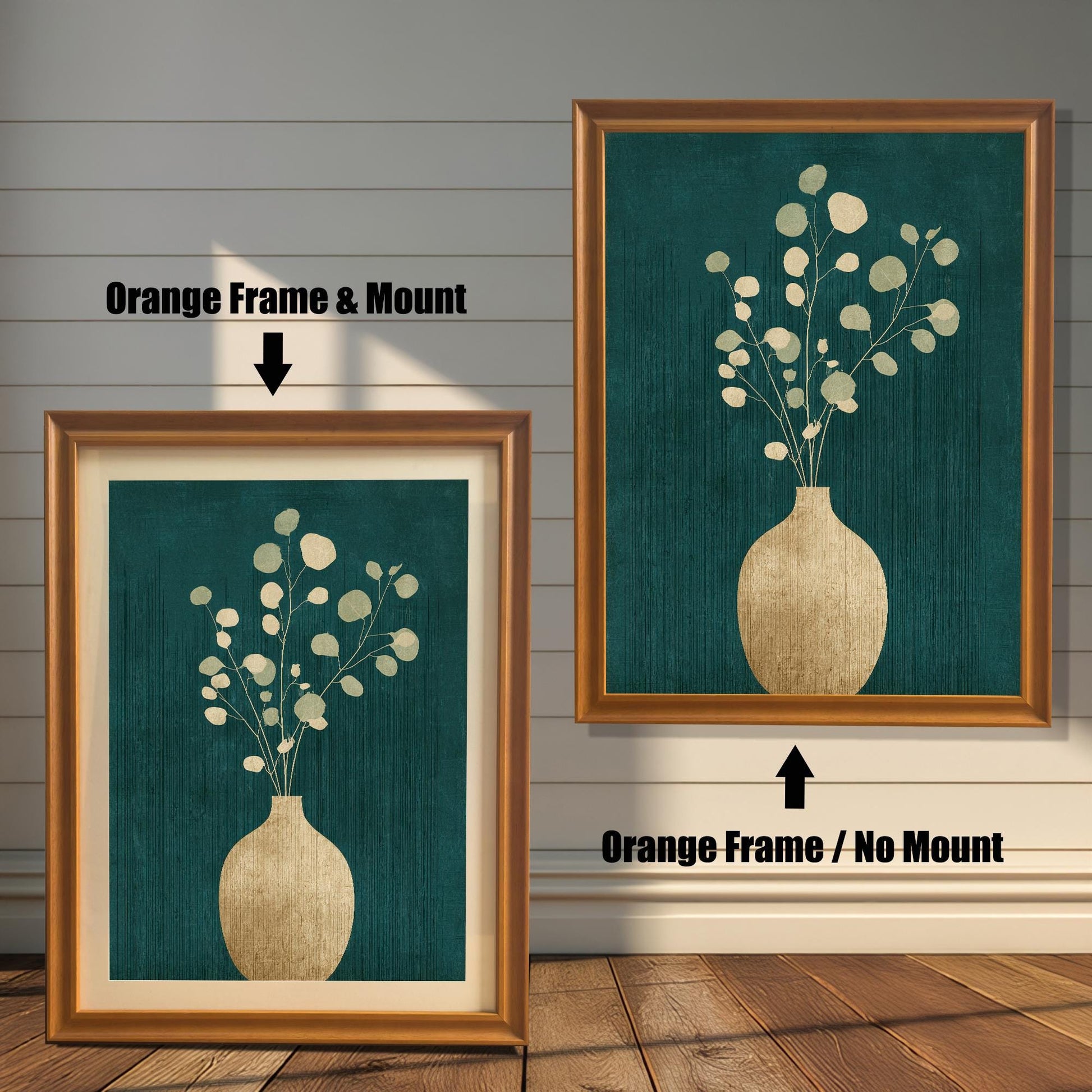 Two side-by-side examples of the orange-toned wood frame; the left frame includes an elegant cream mount, while the right frame displays the full-bleed art print.