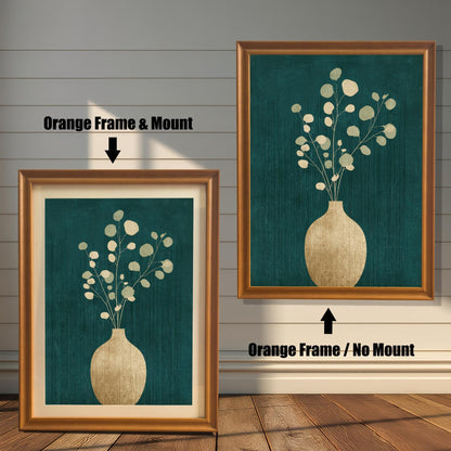 Two side-by-side examples of the orange-toned wood frame; the left frame includes an elegant cream mount, while the right frame displays the full-bleed art print.