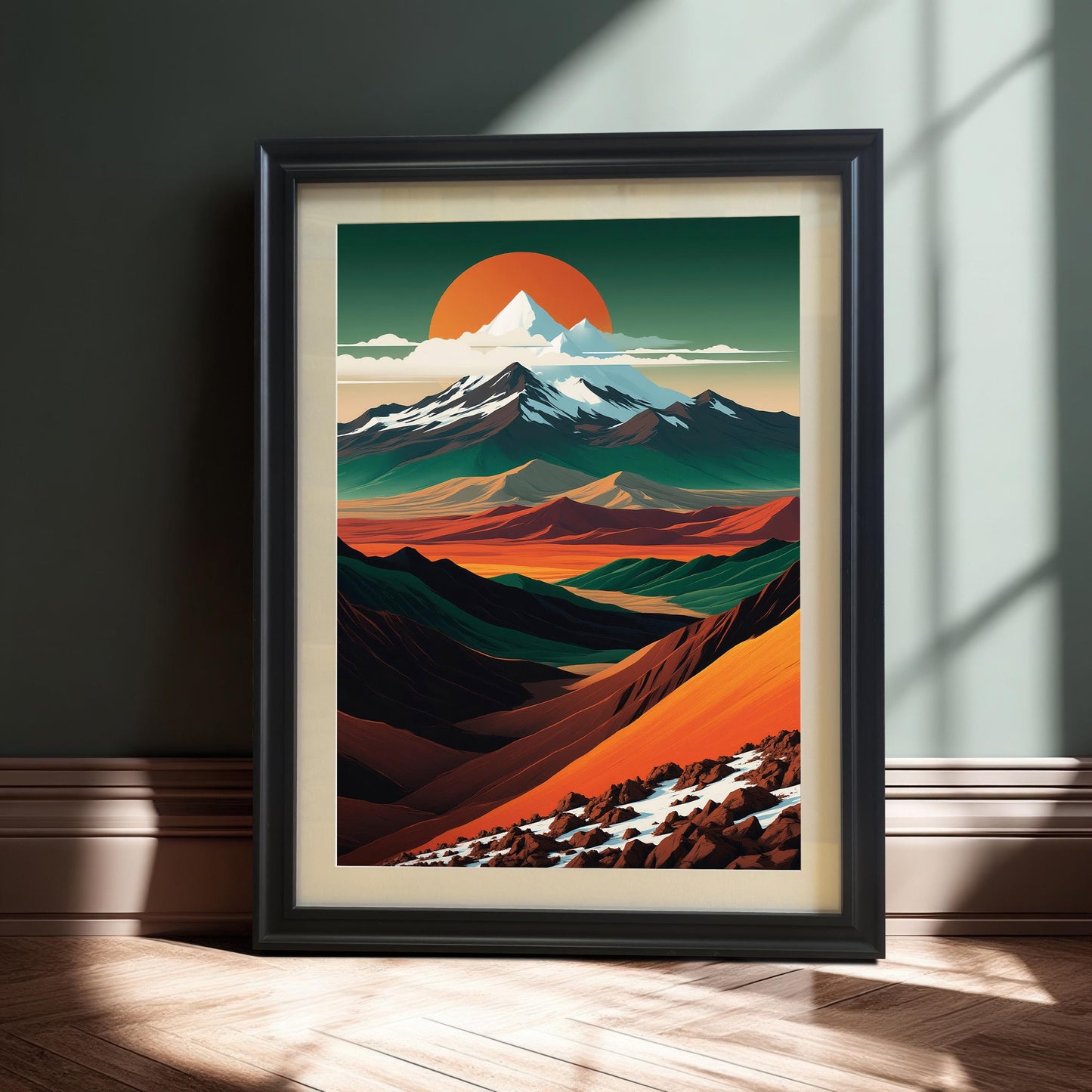 The mountain landscape art in a sleek black wood frame, leaning against a dark teal wall. Dramatic sunlight highlights the texture of the wood floor and the frame.