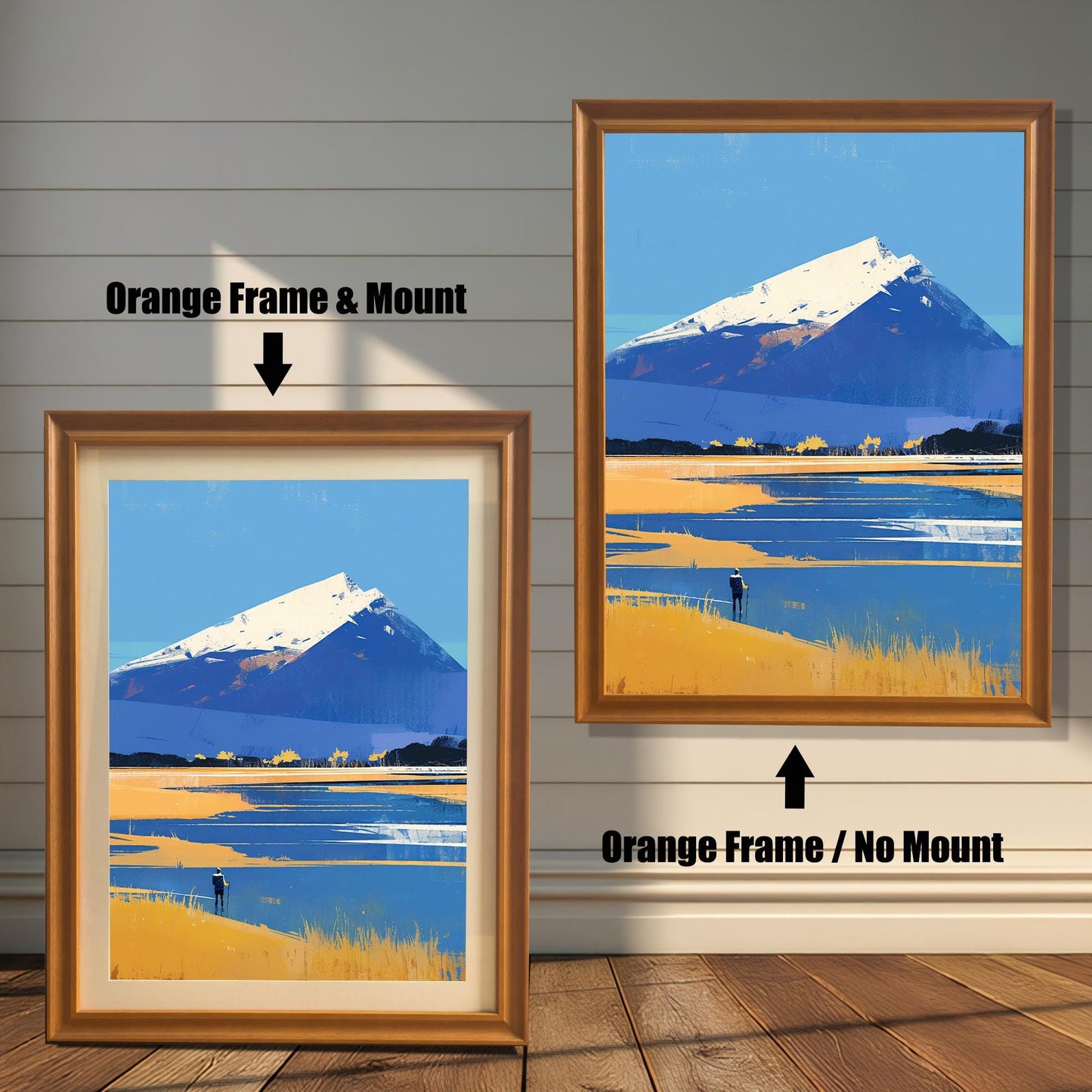 A side-by-side display of the artwork in "Orange Frame" options. The left version includes a mount (matting) inside a warm, honey-toned wood frame. The right version shows the same frame without a mount, with the blue and gold landscape print extending to the frame edges.
