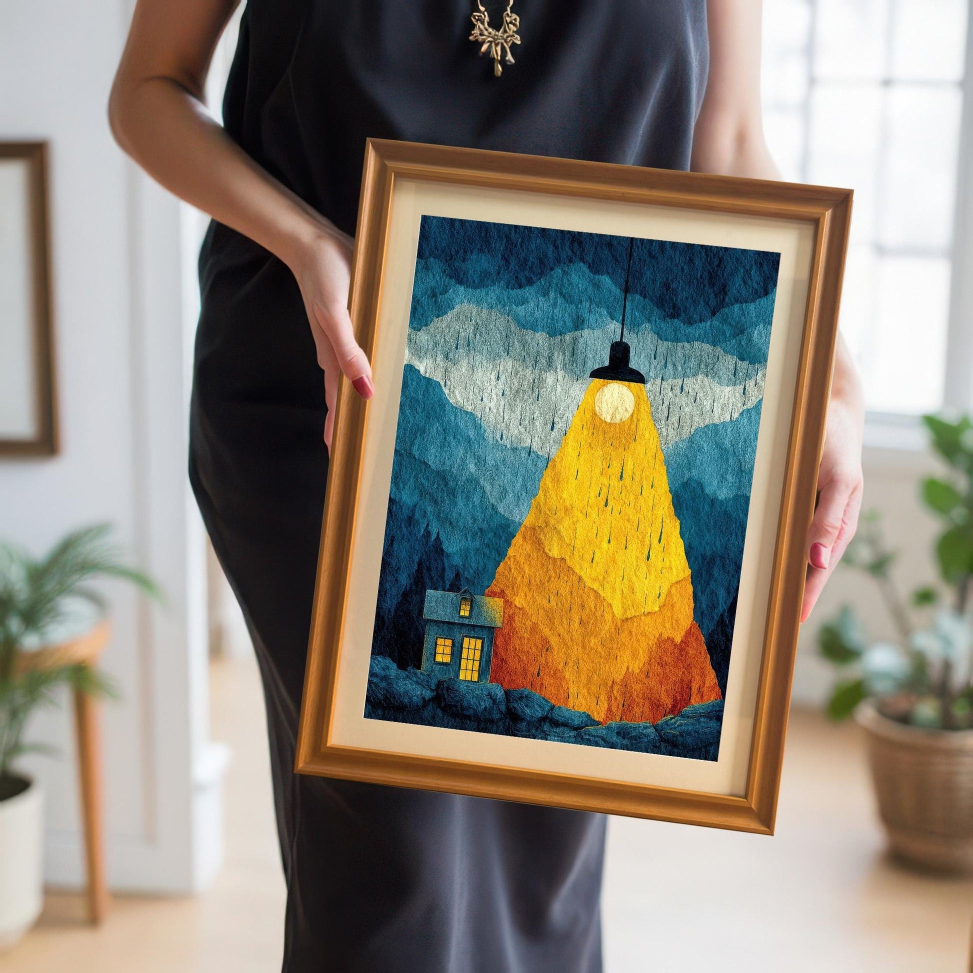 A person holding a medium-sized framed art print in an Orange wood frame with a cream mat board, showing the scale and handheld size of the product.