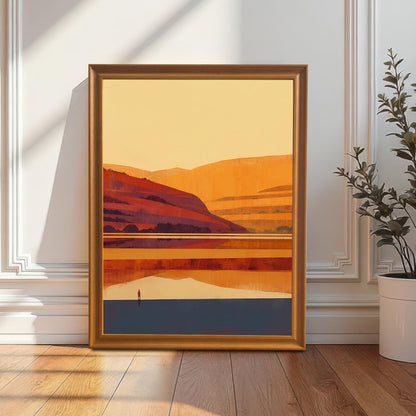 An Orange wood-framed art print leaning against a white wainscoted wall on a hardwood floor next to a potted plant.