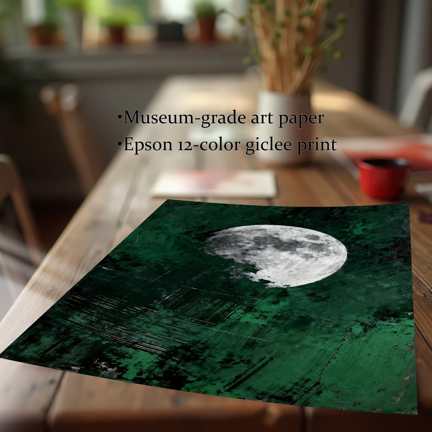 Close-up detail of a dark green moon art print on a wooden table, highlighting the museum-grade art paper and 12-color giclee printing quality.