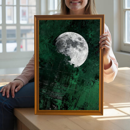 A person holding a large orange-framed moon art print to demonstrate the scale and high-quality finish of the wooden frame and giclee print.