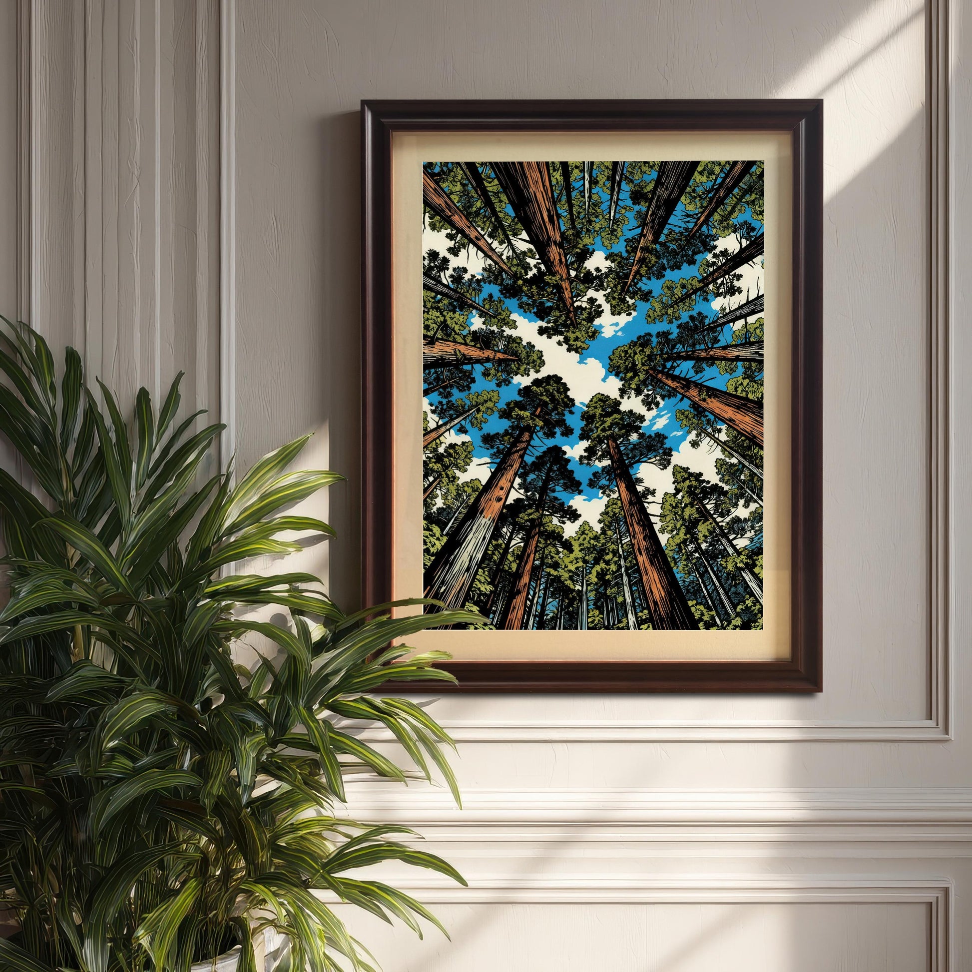 Dark coffee wood framed forest art print hanging on a classic wainscoted wall next to a lush green indoor plant.