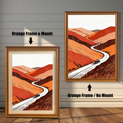 Comparison of the orange-toned landscape print in "Orange" wood frames, showing both the matted and non-matted framing styles against a white paneled wall.