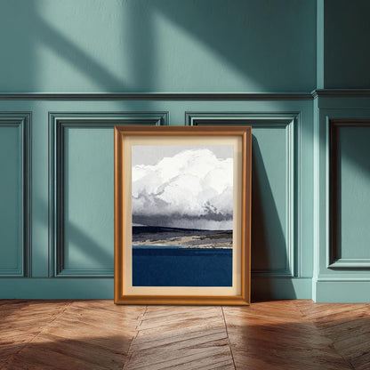 An orange-toned wood-framed print with a mat mount leaning against a teal-blue paneled wall on a herringbone wood floor, captured in soft natural sunlight.
