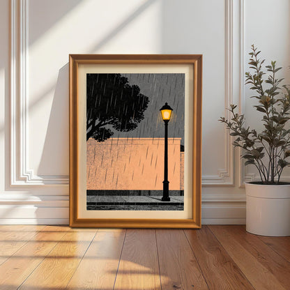 The orange wood-framed art print with a white mount leaning on a light-colored hardwood floor against a white wall with decorative molding, next to a potted plant.