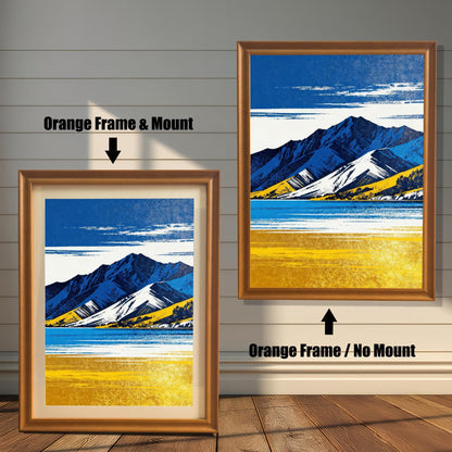 Two framed art prints on a wooden shiplap wall. Both prints feature the same blue and yellow mountain landscape. The left print shows the art in an Orange Frame & Mount (matting). The right print shows the art in an Orange Frame / No Mount.