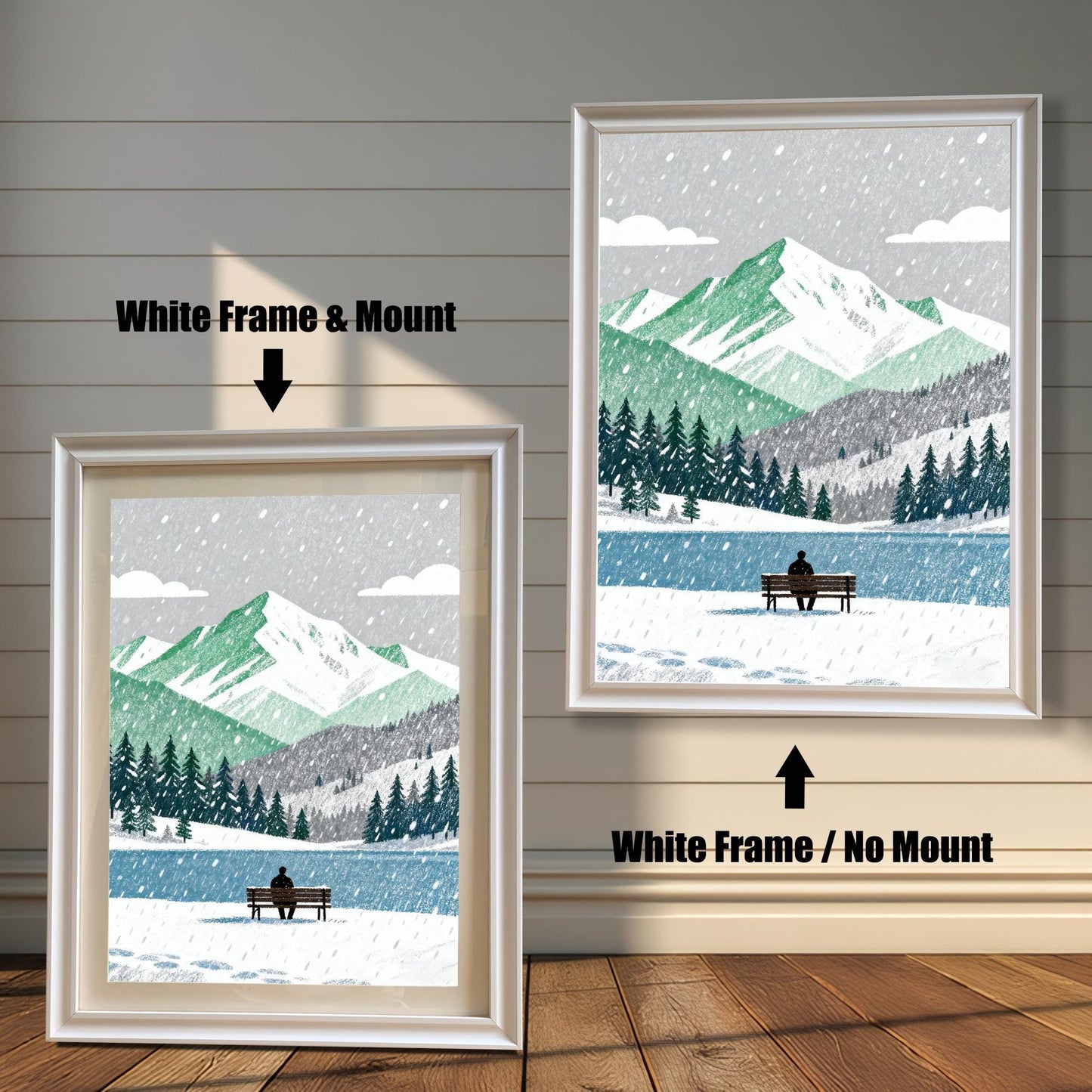 A wood framed art print of a snowy mountain and lake scene. The image shows two framing options: White Frame with a Mount (left, smaller) and White Frame without a Mount (right, larger). A person sits on a bench by the lake.