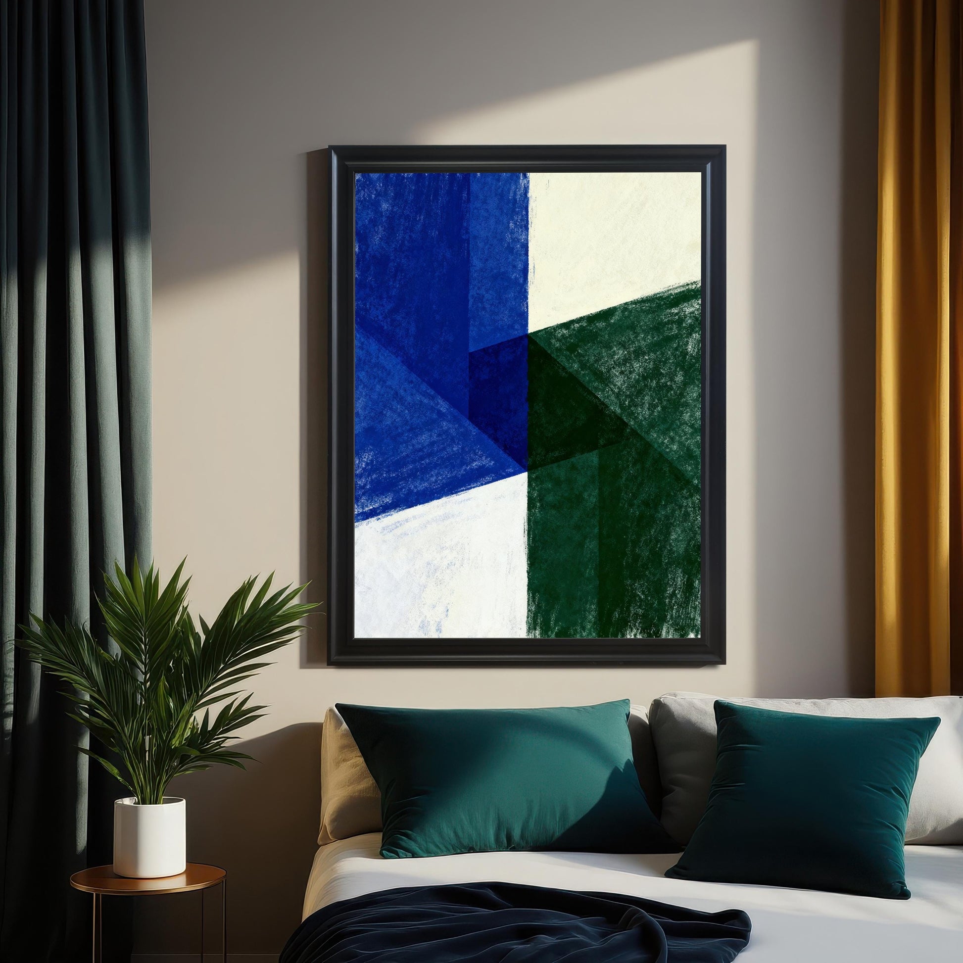 Abstract art print with geometric shapes in dark blue, deep green, and off-white. The print is showcased in a Black Frame and is hanging above a bed with teal and gray pillows, flanked by dark teal and mustard yellow curtains. A potted plant is visible on a side table.