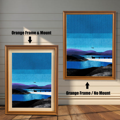 Comparison of two light wood frames; the left is labeled "Orange Frame & Mount" with an inner border, and the right is labeled "Orange Frame / No Mount" showing the full blue landscape print.