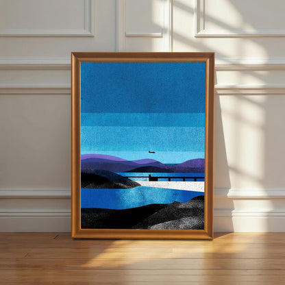 A "Orange" wood-framed landscape art print leaning against a white wainscoted wall on a polished hardwood floor, illuminated by soft, natural morning sunlight.