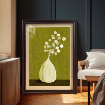 Large-scale botanical art print in a coffee-colored wood frame with a white mount, leaning on a hardwood floor in a modern interior setting.