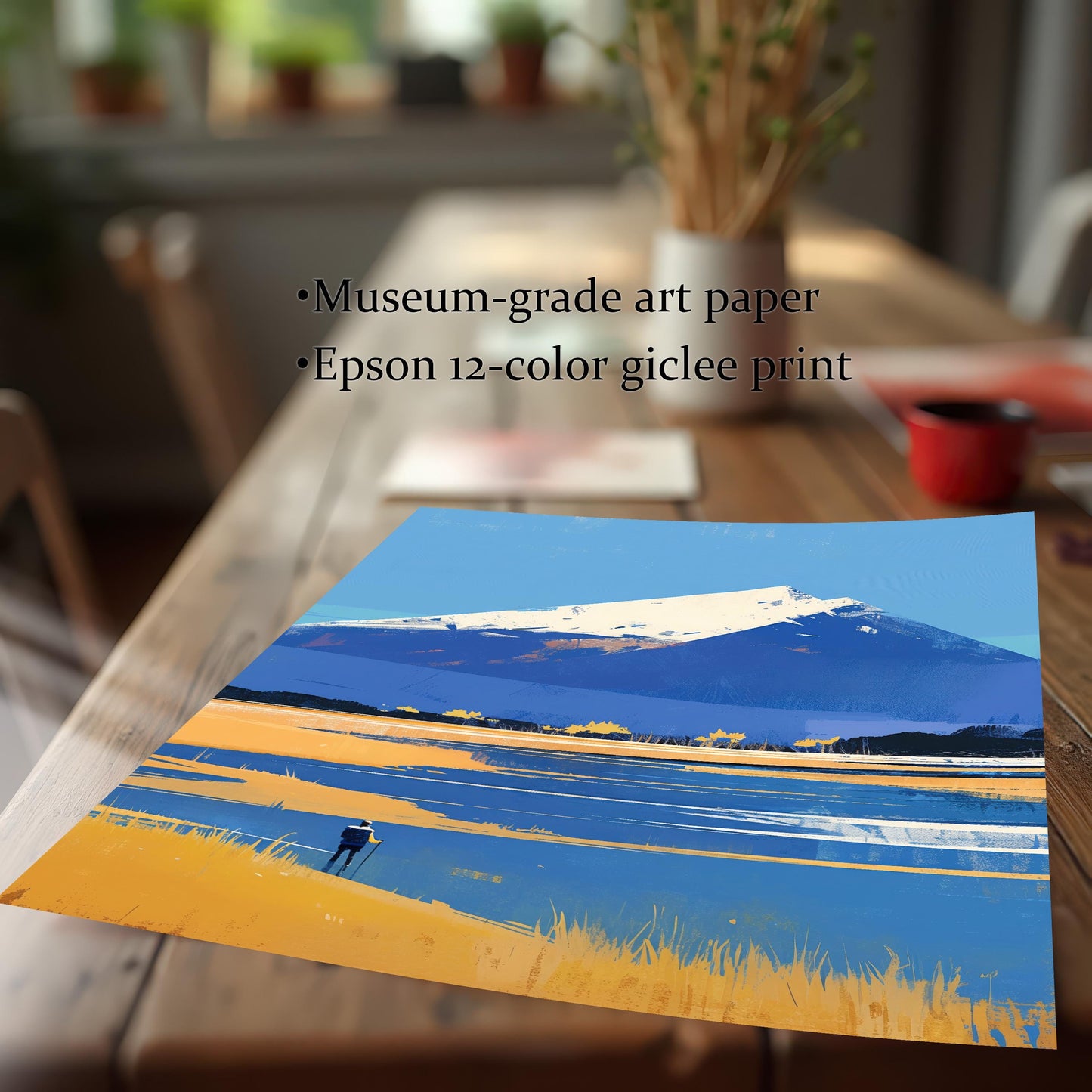 A close-up of the unframed artwork resting on a wooden table. Text overlaid on the image highlights the quality: "Museum-grade art paper" and "Epson 12-color giclee print," emphasizing the vibrant blues and yellows of the mountain illustration.