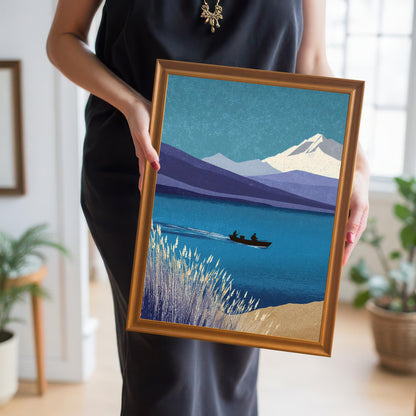 A person holding a medium-sized orange wood framed print of the mountain and lake scene, providing a real-life sense of scale and handling.