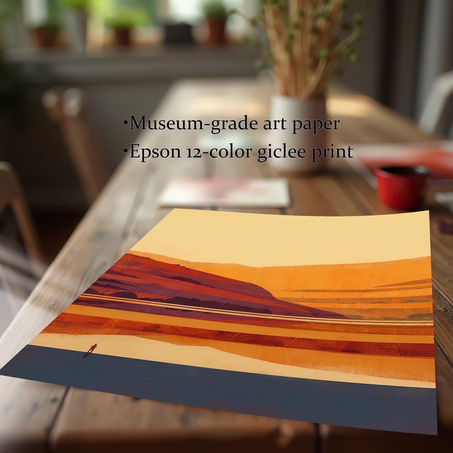 Detail shot of a museum-grade art paper print on a wooden table, featuring an Epson 12-color giclee print of a sunset landscape.