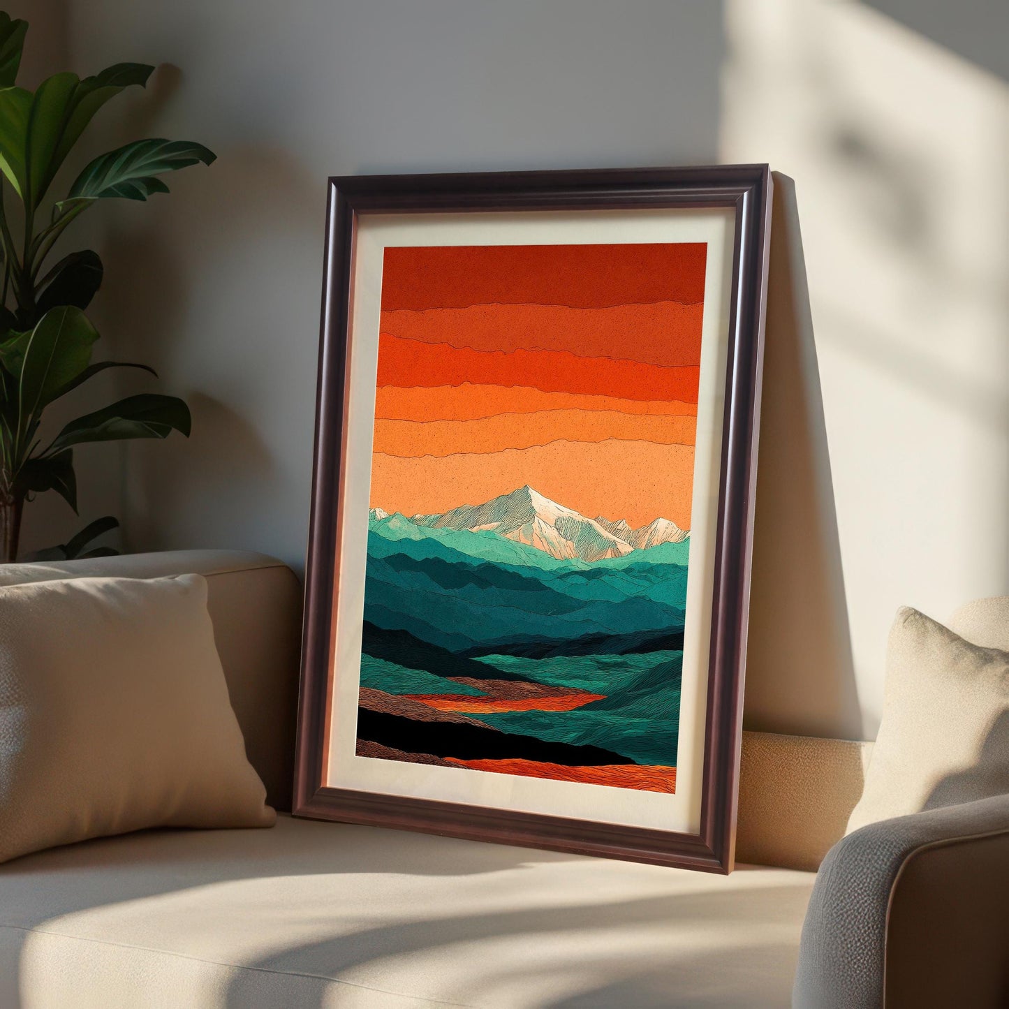 A coffee-colored wood frame with a cream mount leaning on a beige sofa next to a green indoor plant, illuminated by soft natural sunlight.