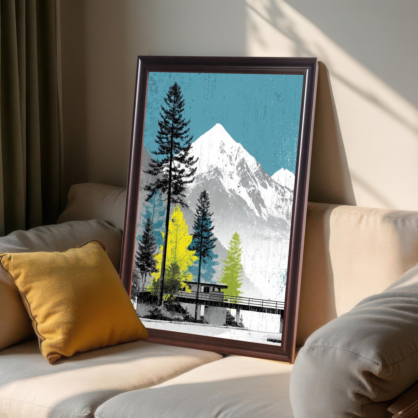 Coffee-colored dark wood frame featuring a mountain and forest art print, leaning against a neutral-toned sofa in natural sunlight.