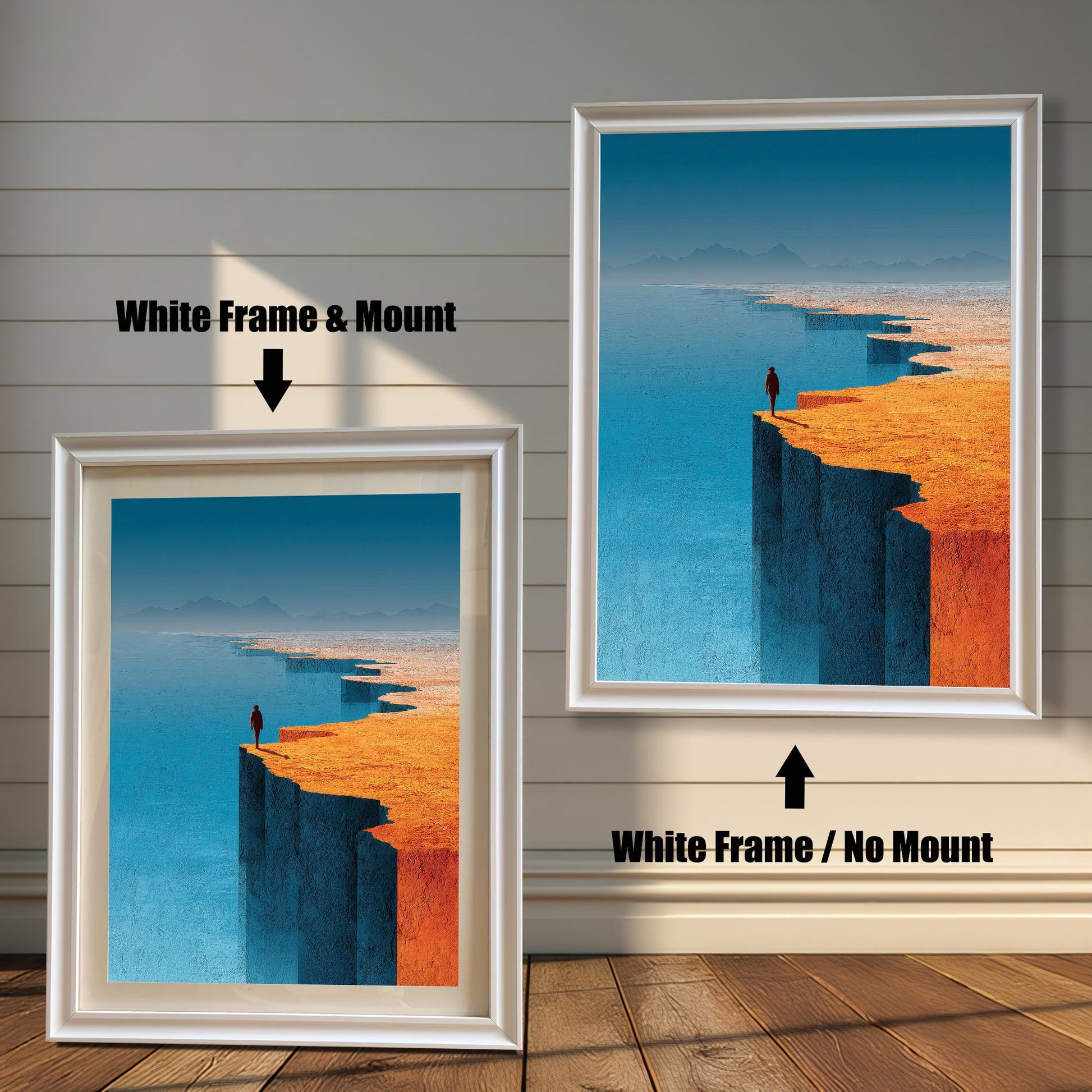A side-by-side comparison of two white-framed landscape art prints on a shiplap wall. The left frame features a decorative white mount, while the right frame shows the artwork without a mount.