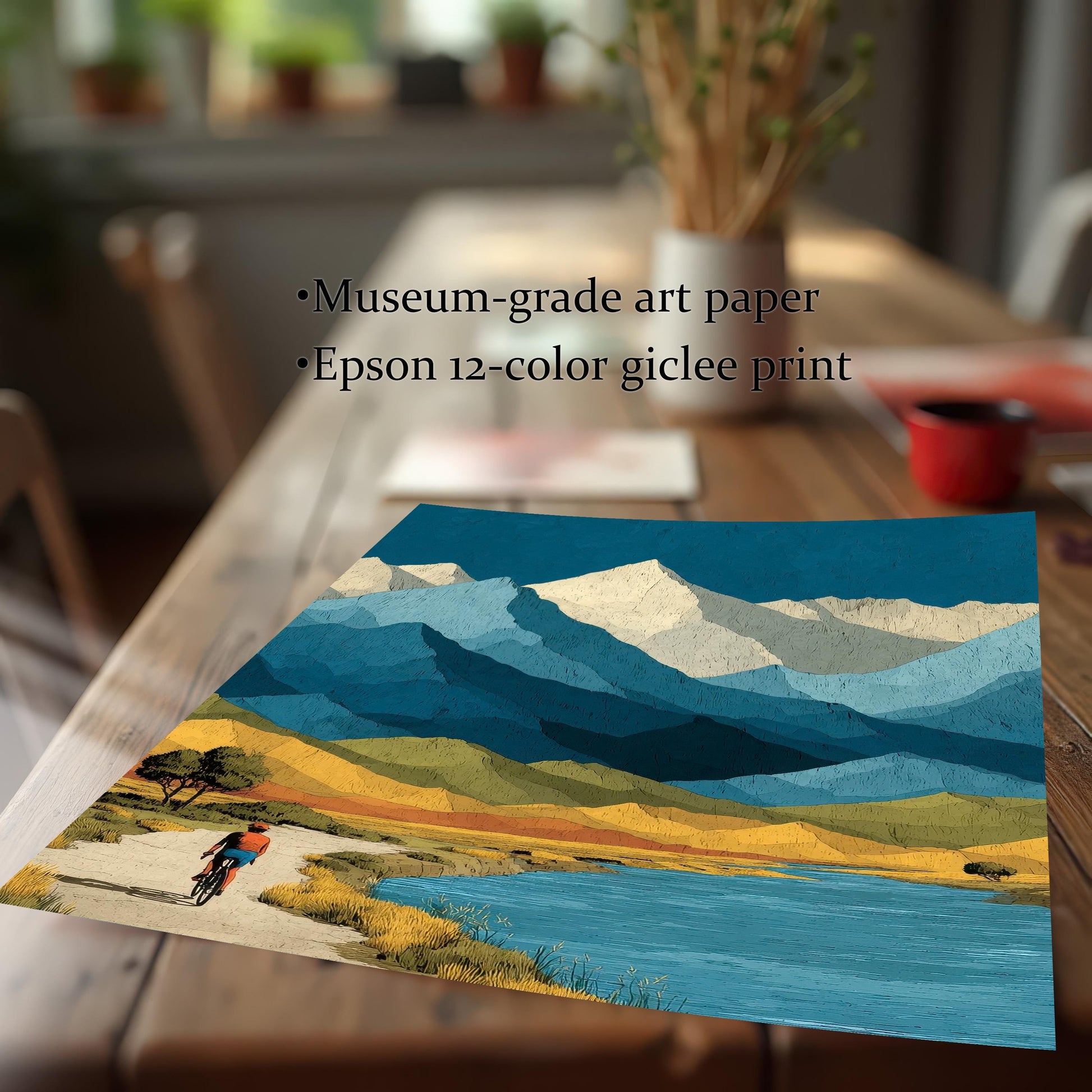 Close-up of a mountain landscape art print on a wooden table, featuring text overlays: "Museum-grade art paper" and "Epson 12-color giclee print."