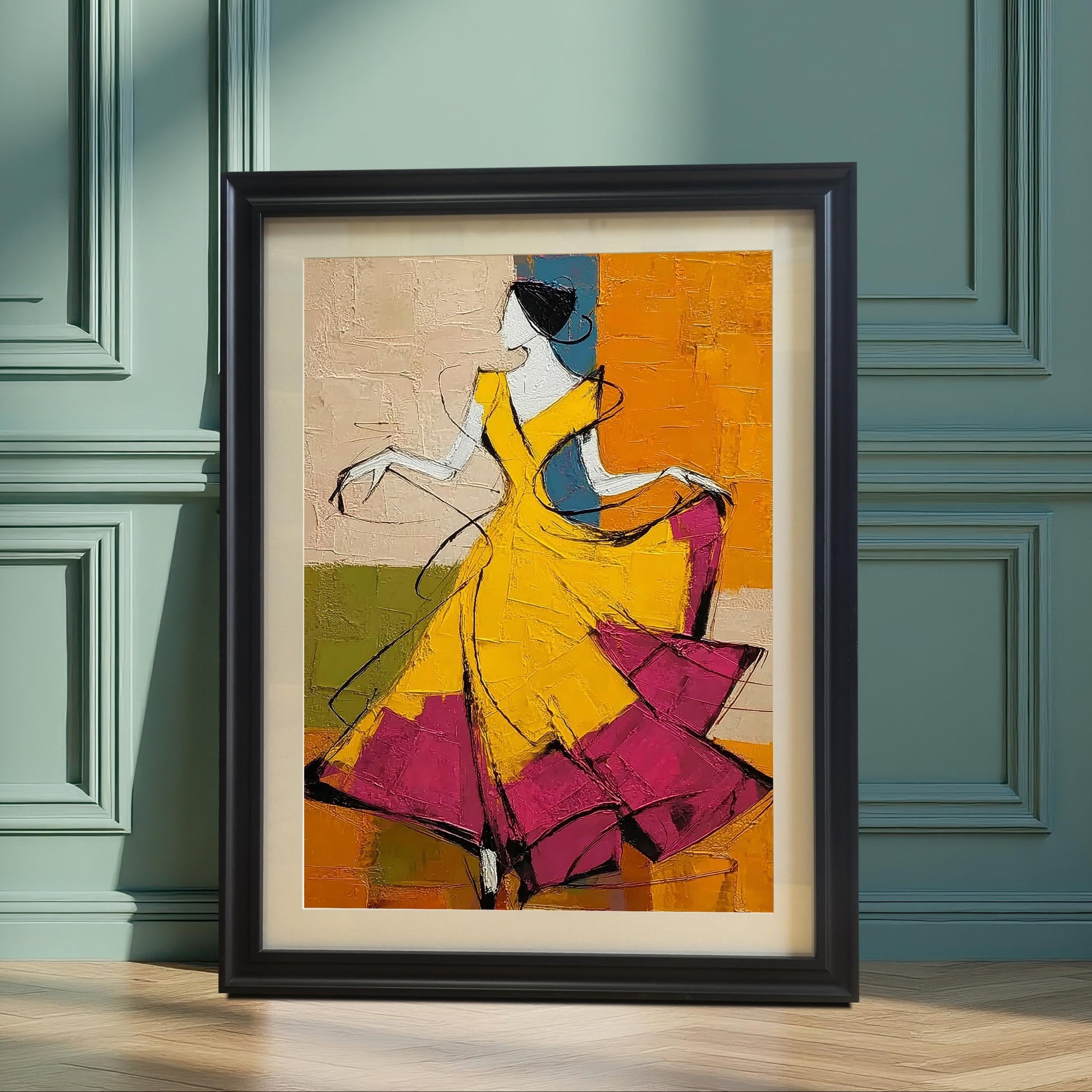 A black-framed art print of a dancer in a yellow and magenta dress leaning against a teal-paneled wall. The sunlight creates dramatic shadows across the wall and wooden floor.