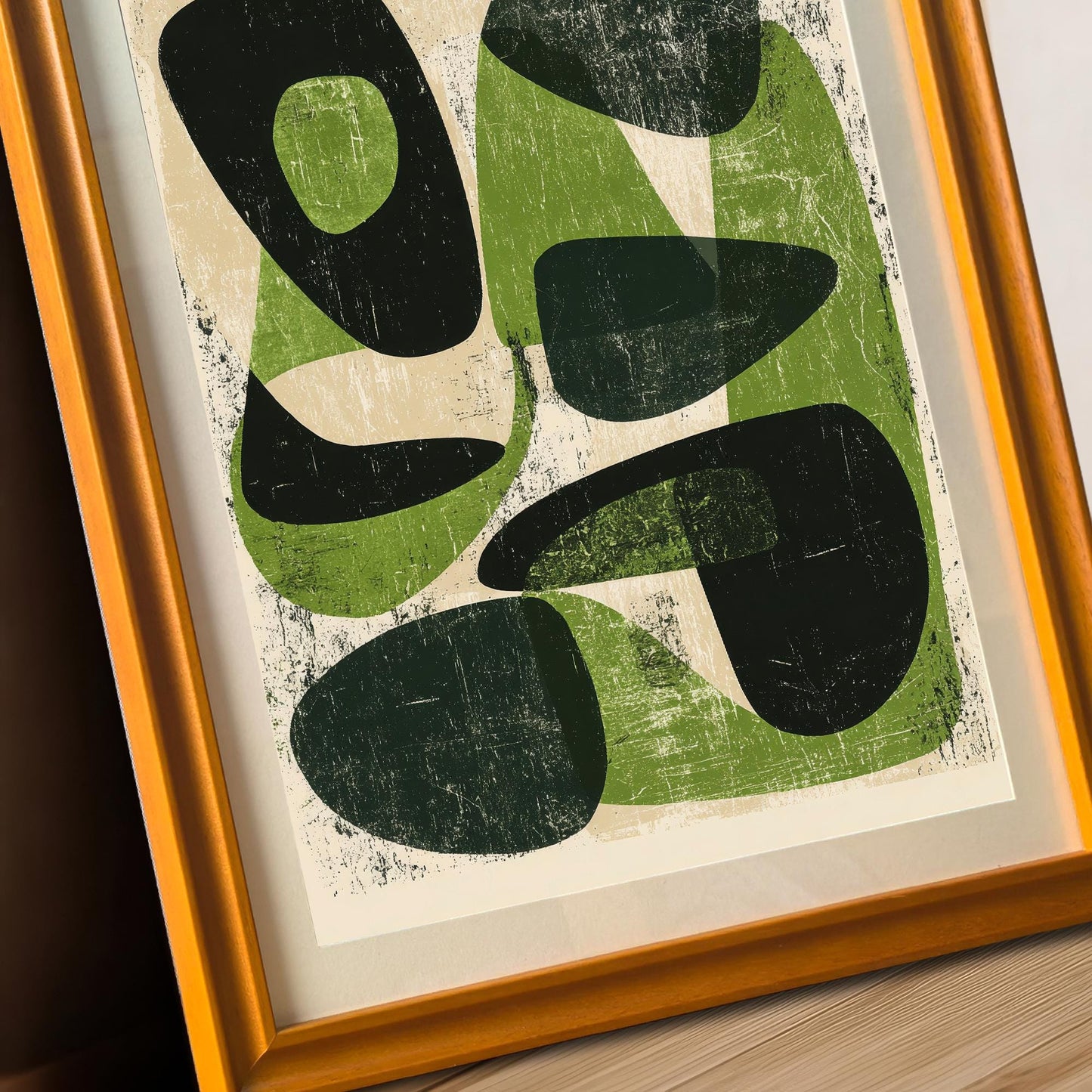 An angled close-up of the green and black abstract art in an orange wood frame, highlighting the matte finish of the museum-grade paper and the clean lines of the frame.