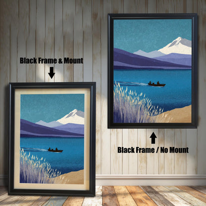 Comparison of two black wood frames against a light wood-paneled wall. The left frame shows the landscape art with a cream-colored mount, while the right frame shows a full-bleed print with no mount. Text labels indicate "Black Frame & Mount" and "Black Frame / No Mount"