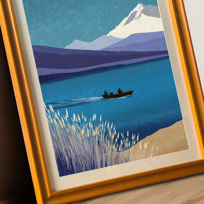 Angled close-up of the landscape art in an orange wood frame with a cream mount, highlighting the crisp printing of the mountain, lake, and boat details.