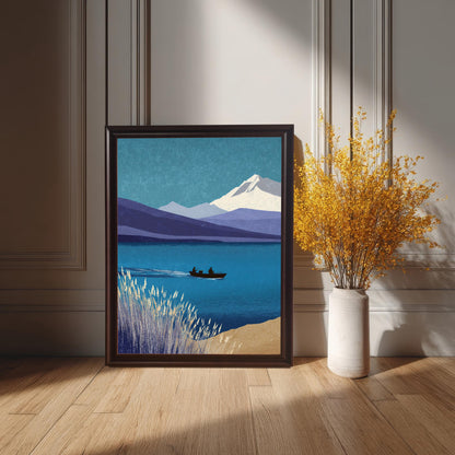 A large, full-bleed art print in a coffee-colored wood frame sitting on a light oak floor. It is positioned next to a white ceramic vase filled with tall, yellow dried flowers against a classic white wainscoted wall.