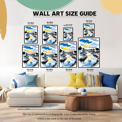 A ""WALL ART SIZE GUIDE"" image showing a framed sketch-style print of a river reflecting a colorful sunset/sunrise sky, with white houses on its banks. The art is displayed in eight different size options (12x16, 14x18, A4, 10x12, 15x21, 16x20, 16x24, 20x28 inches) above a white sectional sofa