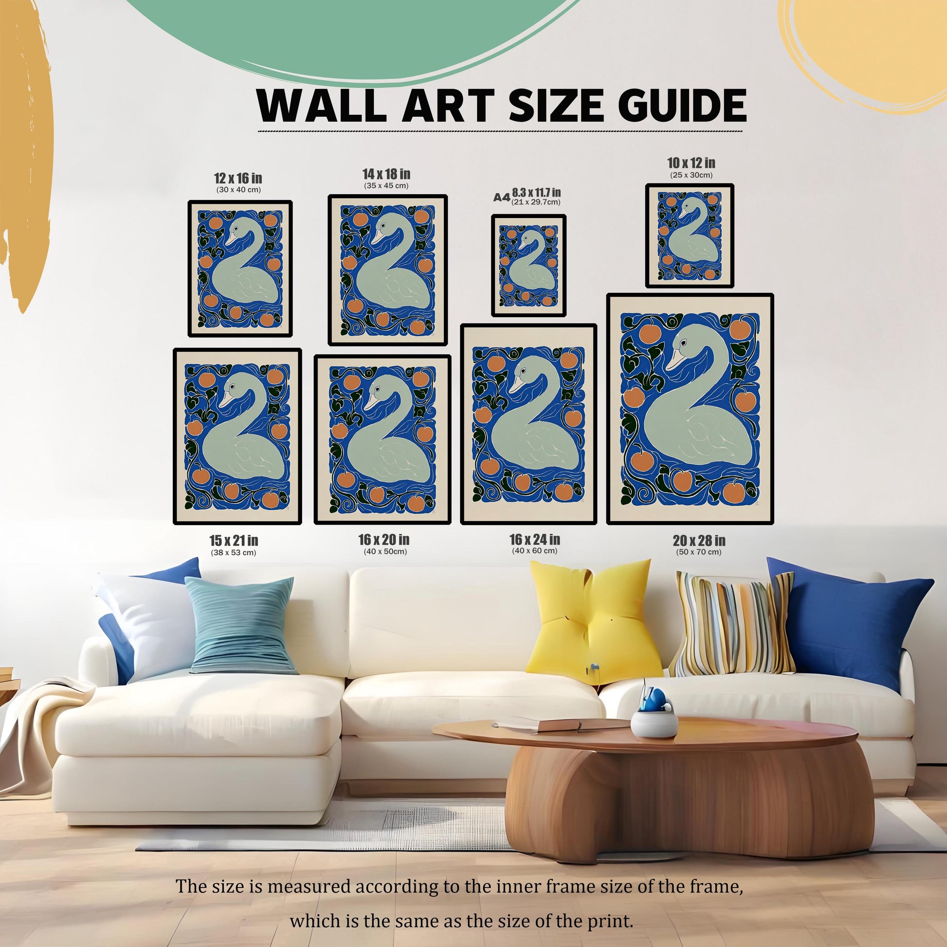 WALL ART SIZE GUIDE. A photo showing various framed sizes of the swan print placed above a white sofa with colorful pillows, demonstrating size against furniture. Sizes range from 10x12 in to 20x28 in.