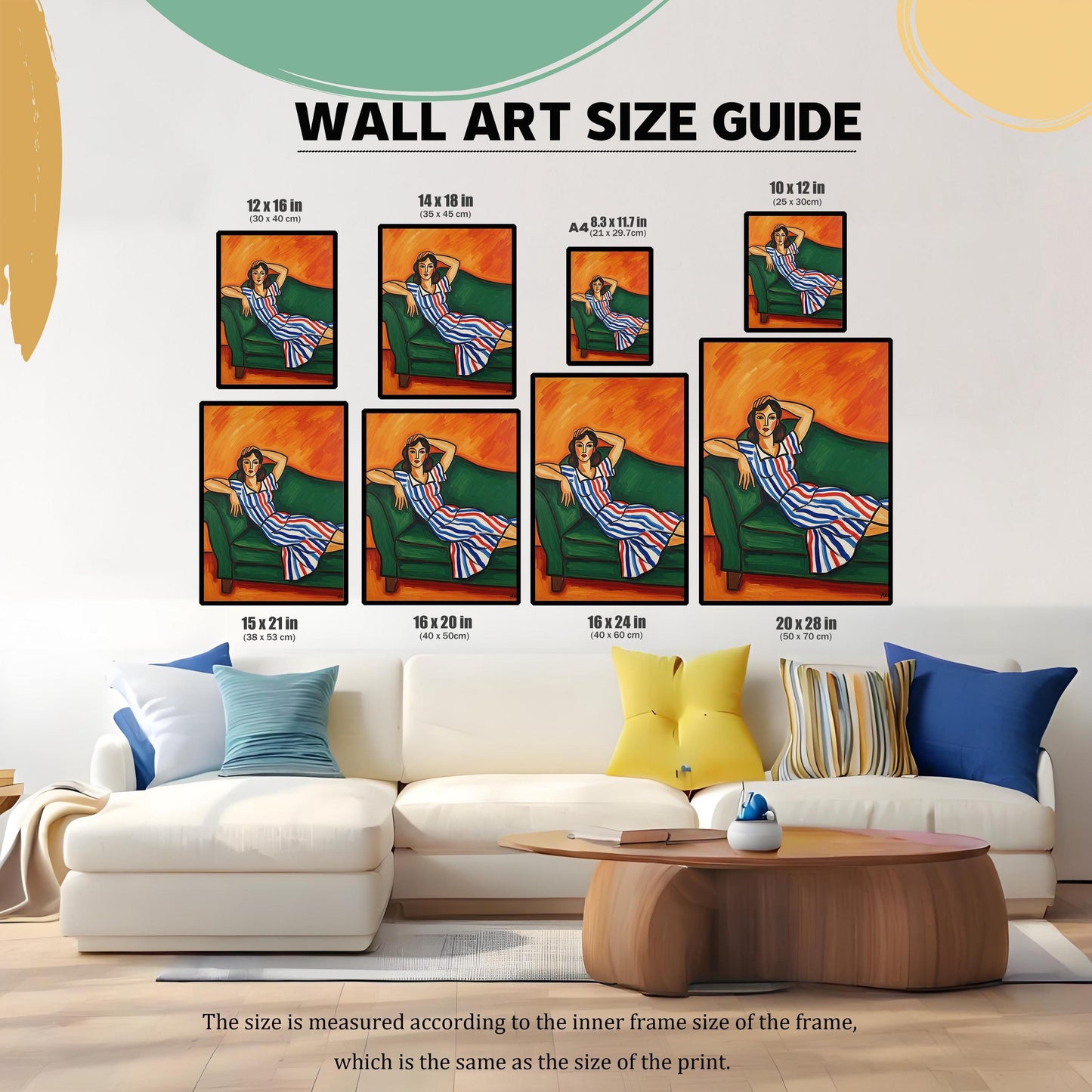 A wall art size guide displays an art print of a seated woman in a blue, white, and red striped dress. The prints are shown on a wall above a white sectional couch.