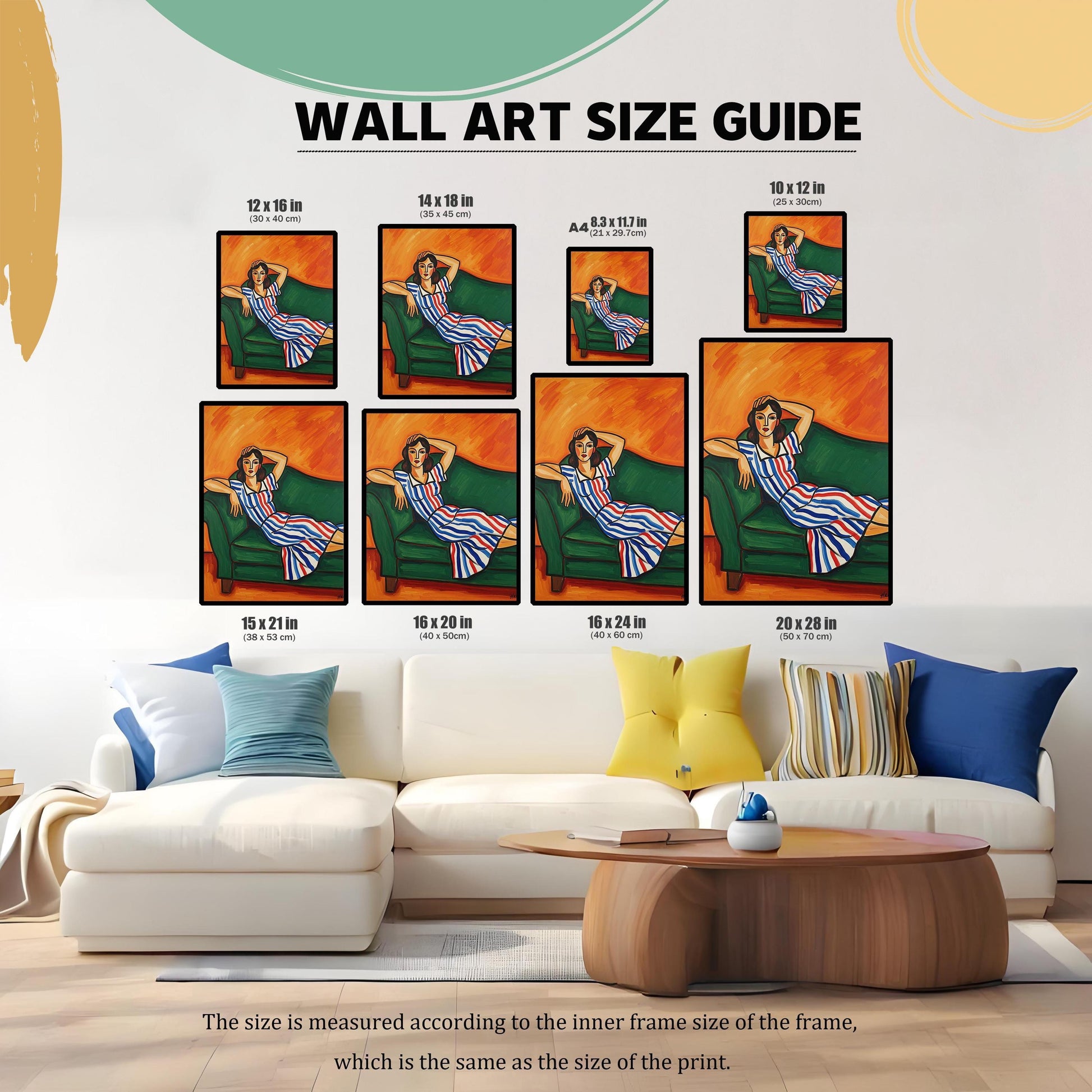 A wall art size guide displays an art print of a seated woman in a blue, white, and red striped dress. The prints are shown on a wall above a white sectional couch.