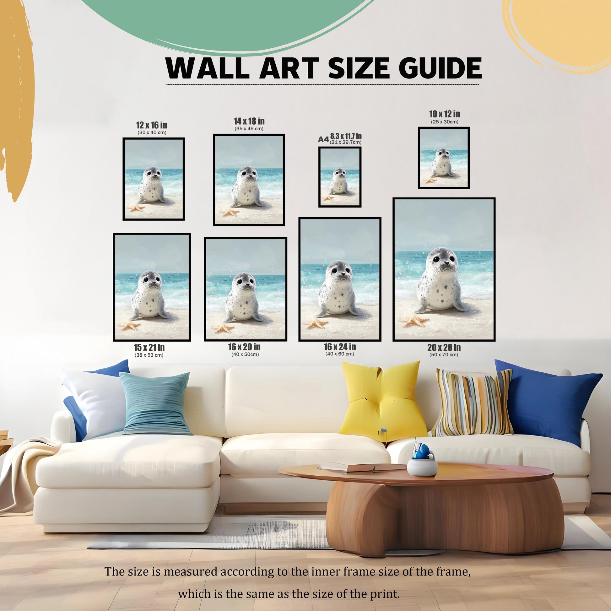 A wall art size guide displays the baby seal print in various sizes, ranging from 8.3x11.7 inches (A4) to 20x28 inches. The prints are arranged over a white sofa with pillows to help visualize the different dimensions.