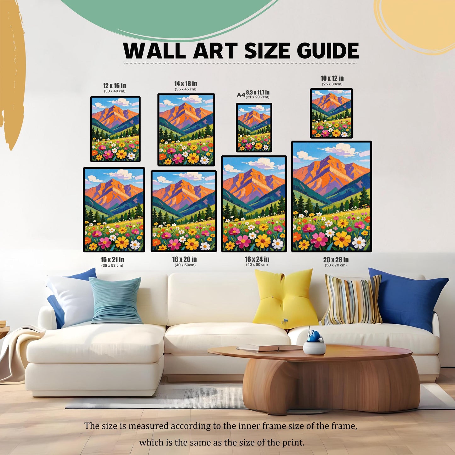 A visual size guide shows various sizes of a mountain landscape art print, with measurements in inches and centimeters, arranged on a wall above a couch.