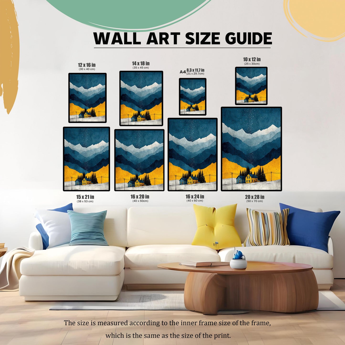 A ""WALL ART SIZE GUIDE"" image showing a watercolor print of a winter landscape with mountains and a yellow house, displayed in various frame sizes (12x16, 14x18, A4, 10x12, 15x21, 16x20, 16x24, 20x28 inches) over a white couch in a living room.