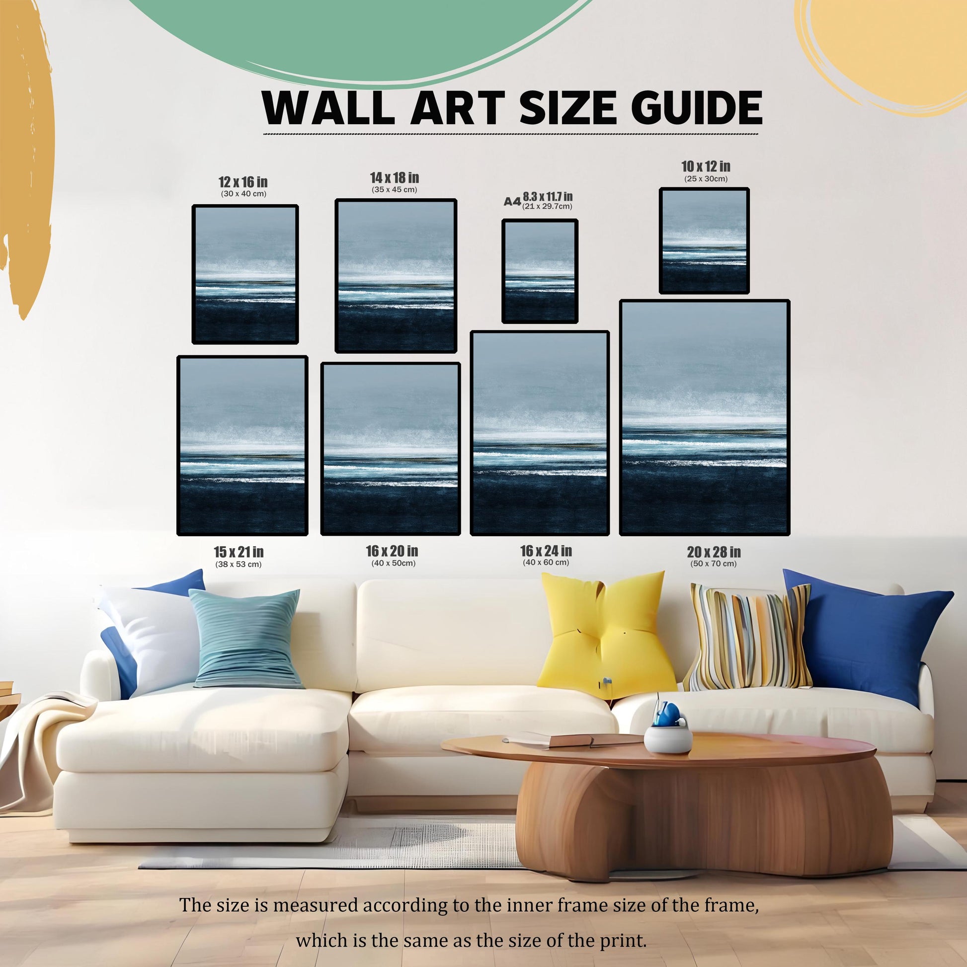 Wall Art Size Guide graphic showing eight different framed sizes (e.g., 12×16 in, 16×24 in, A4) for the seascape print. The guide is superimposed over a white sectional couch in a living room, illustrating the print's scale.
