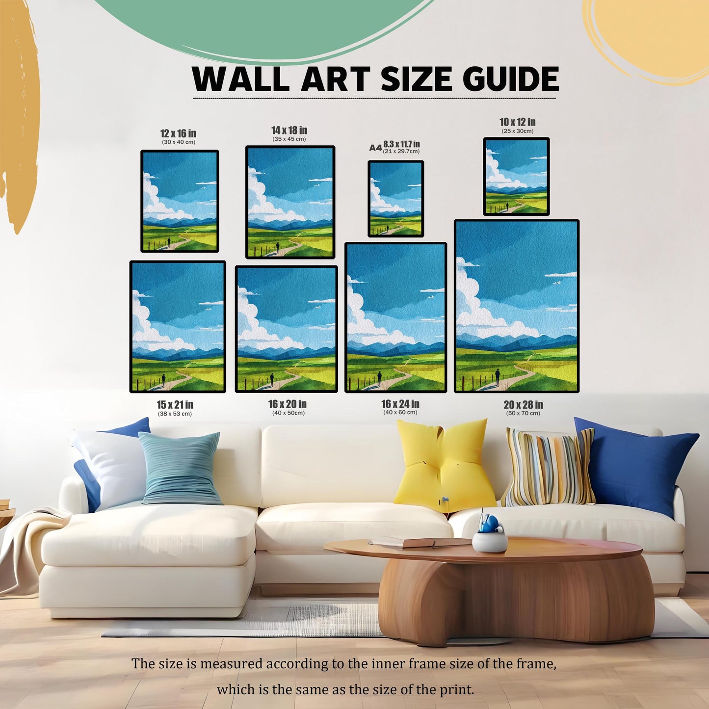 Wall Art Size Guide graphic showing eight different framed sizes (e.g., 12×16 in, 16×24 in, A4) for the landscape print. The size guide is superimposed over a white sectional couch in a living room, helping to visualize the scale of the print.