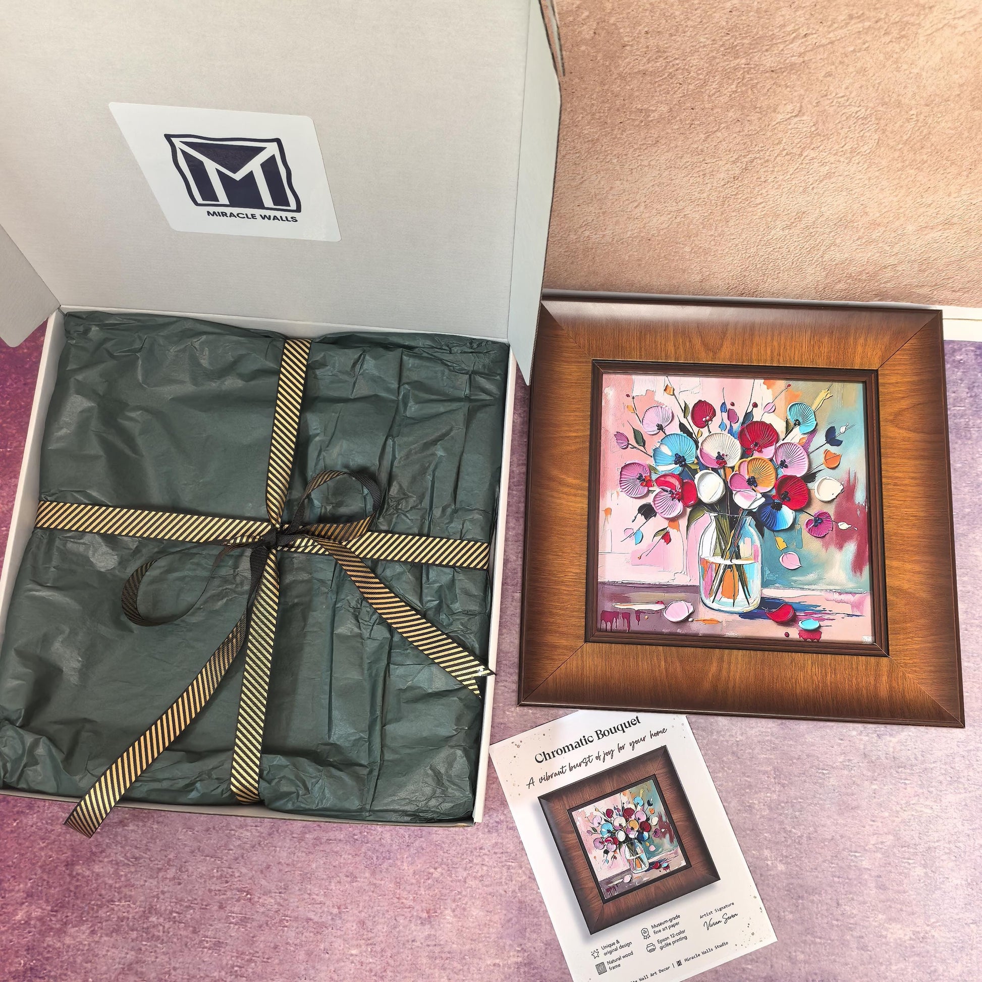 A "Chromatic Bouquet" wood-framed art print featuring vibrant, 3D-style colorful flowers in a glass vase. The print is displayed next to its premium gift packaging—a white Miracle Walls box with green tissue paper and a gold-striped ribbon—and a product certificate of authenticity.