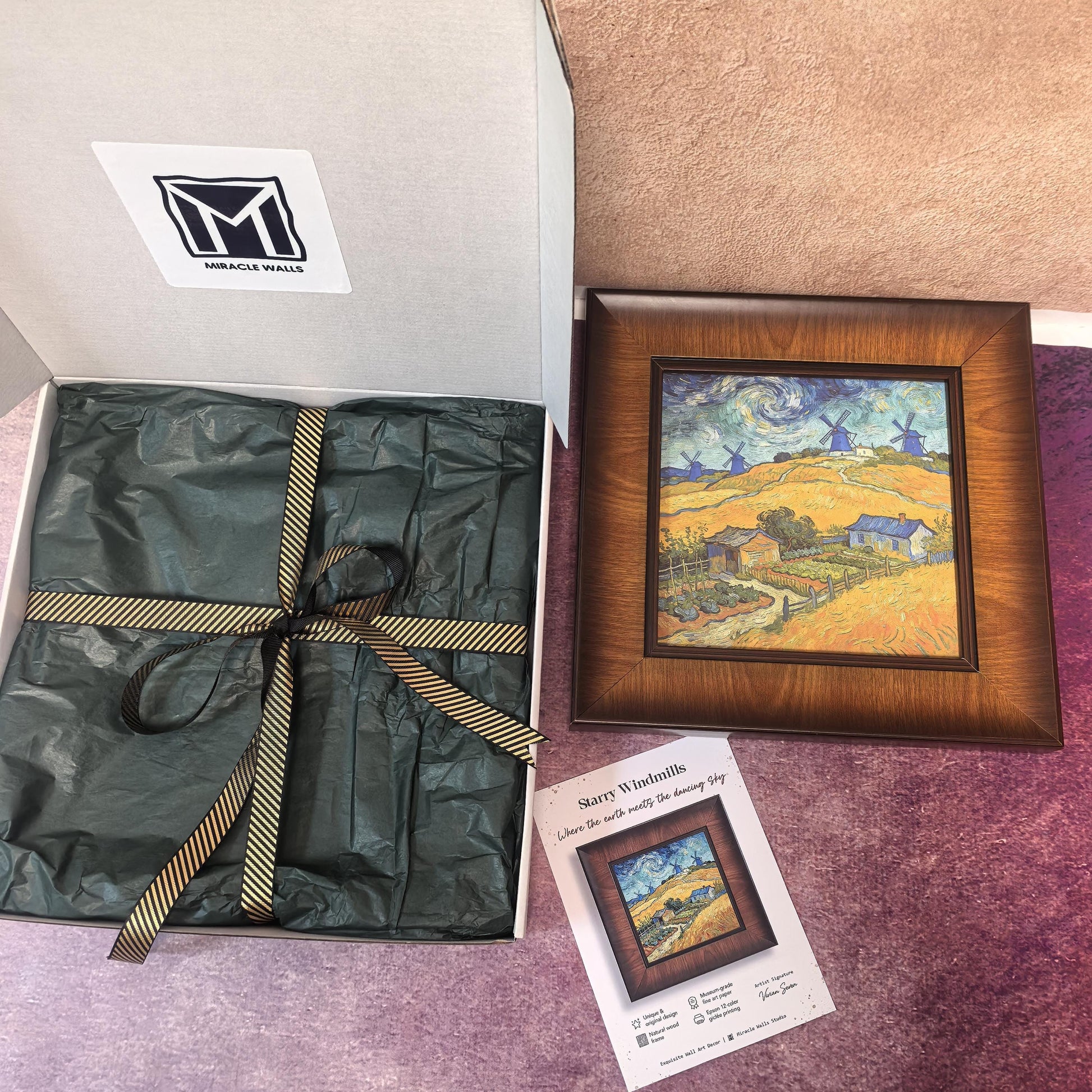 A wooden framed art print titled "Starry Windmills" by Miracle Walls, inspired by Van Gogh’s style, featuring golden fields and blue windmills under a swirling night sky. It is displayed next to its branded gift packaging, which includes a white box with a logo, green tissue paper, and a gold-striped ribbon.