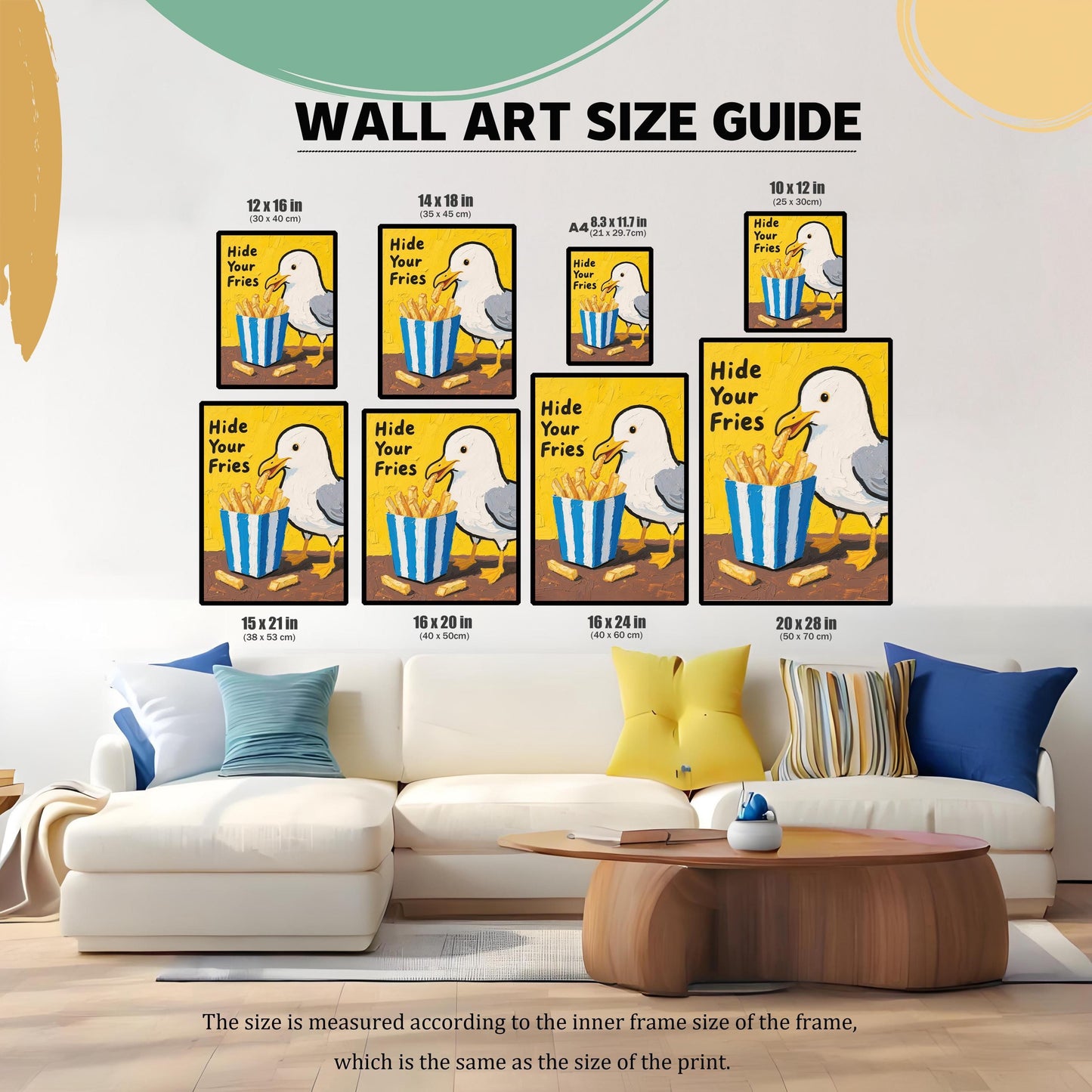 A size guide showing framed prints of a seagull and fries above a white couch. The prints are shown in various sizes, including 12x16, 14x18, 8.3x11.7, 10x12, 15x21, 16x20, 16x24, and 20x28.