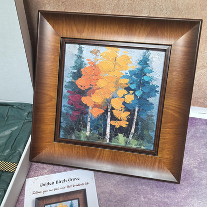 A direct view of the "Golden Birch Grove" framed art, highlighting the thick, impasto texture of the yellow, orange, and teal birch trees. The artwork is encased in a wide, elegant wood frame with a warm brown finish.