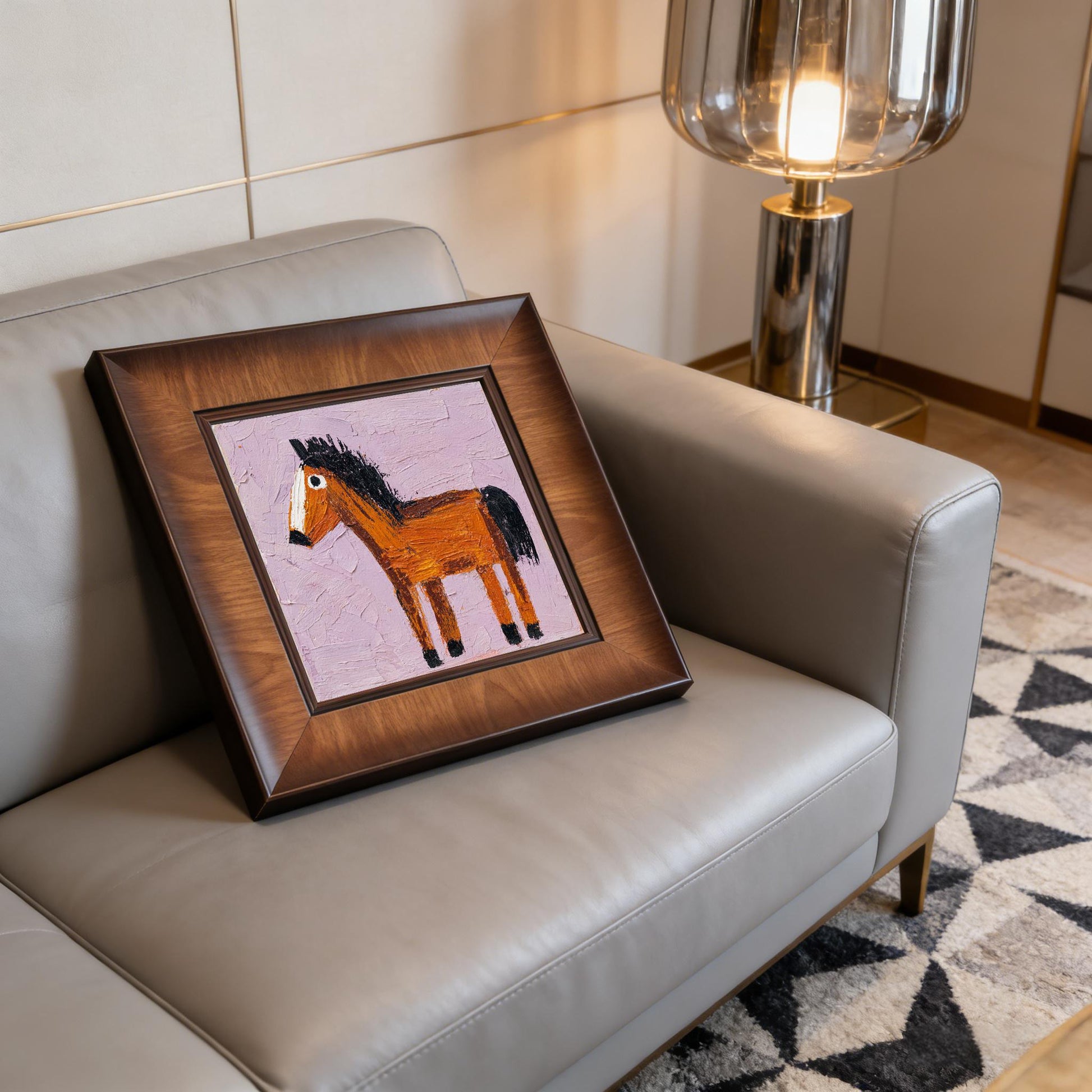 Square horse print in a premium wood frame resting on a leather sofa, illuminated by the warm glow of a modern glass floor lamp.