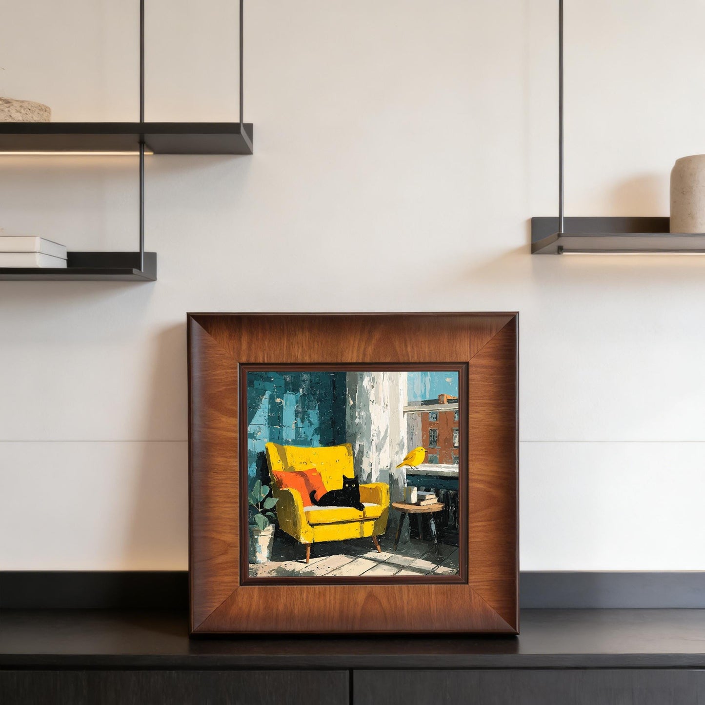Square wood-framed cat painting displayed on a modern black console table beneath minimalist wall shelves.