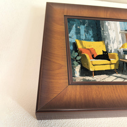 A close-up view focused on the details of the oil-style painting inside the rich, walnut-finish frame, showing the black cat and yellow chair clearly.