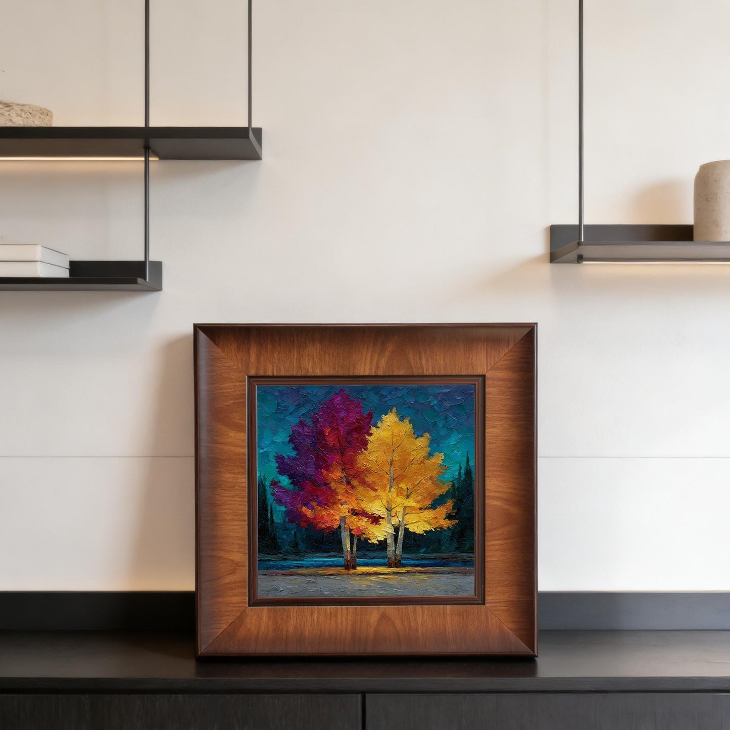 Square-framed impressionist landscape displayed on a modern black sideboard with minimalist shelving and soft overhead lighting.